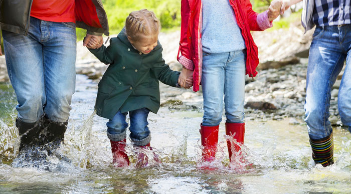 Family jumping in puddle (Shutterstock, Dasha Petrenko)
