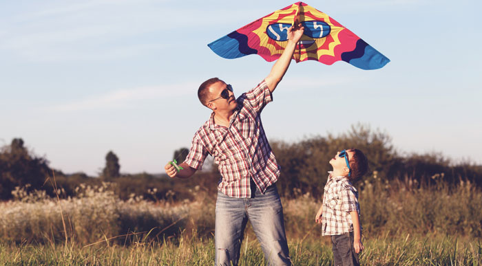 Father-and-son-playing-with-kite-(Shutterstock_altanaka)