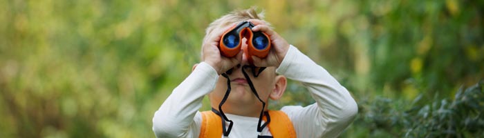 boy with binoculars in forest (shutterstock, TheFarAwayKingdom )