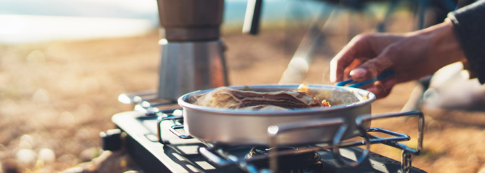 Cooking on Camping Stove (Shutterstock, Maria Savenko)