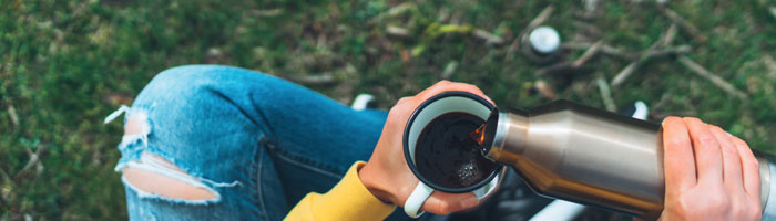 Girl drinking coffee outside (Shutterstock, Maria Savenko)