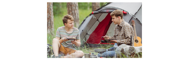 Two-men-eating-while-camping