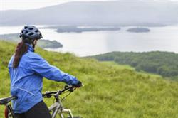woman cycling in scotland (shutterstock, sirtravelalot)