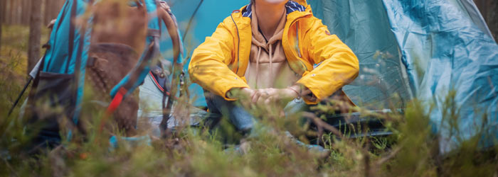 Woman in a tent in a forest (Shutterstock, Olesya Kuznetsova)