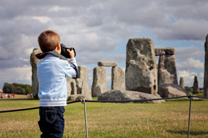 Boy taking picture of Stonehenge (shutterstock, Tomsickova Tatyana)